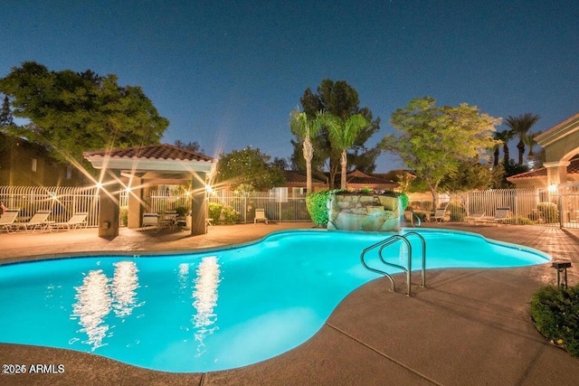 view of swimming pool featuring a gazebo, a water slide, and a patio