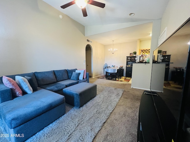 living room with lofted ceiling, ceiling fan with notable chandelier, and carpet