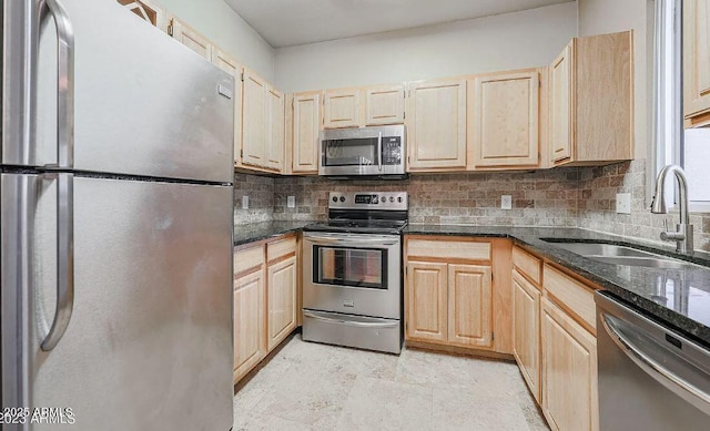 kitchen featuring tasteful backsplash, appliances with stainless steel finishes, sink, and light brown cabinetry