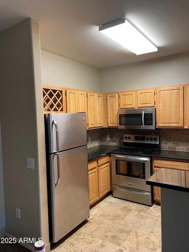 kitchen with stainless steel appliances, light brown cabinetry, a textured ceiling, and backsplash