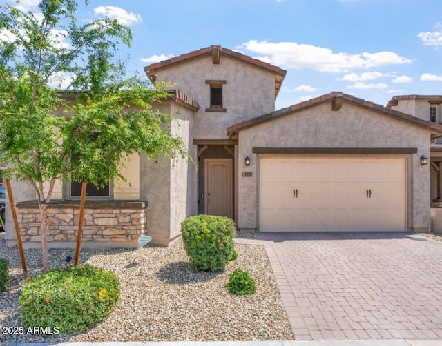 1895 N 141st Ave, Goodyear, AZ 85395 - mediterranean / spanish house with stucco siding, decorative driveway, an attached garage, and a tiled roof