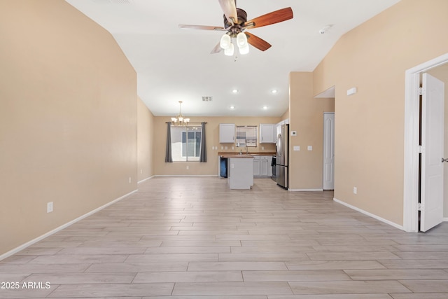unfurnished living room featuring light wood-type flooring, baseboards, ceiling fan with notable chandelier, and visible vents
