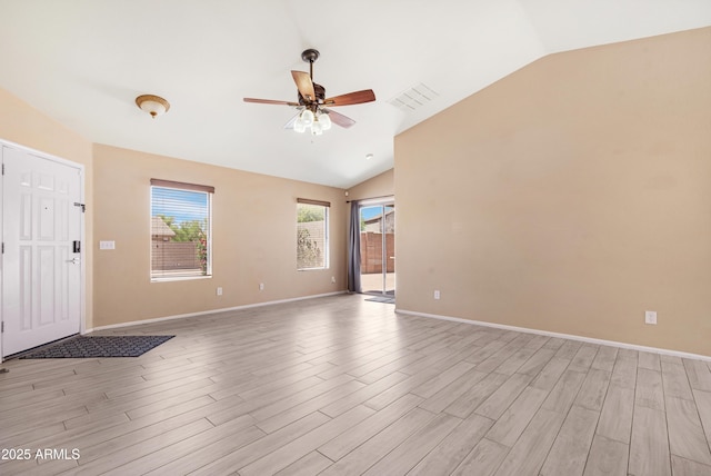 unfurnished living room featuring baseboards, ceiling fan, vaulted ceiling, and light wood-style flooring