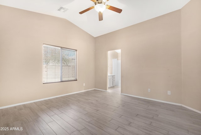 empty room featuring visible vents, ceiling fan, vaulted ceiling, and light wood-type flooring