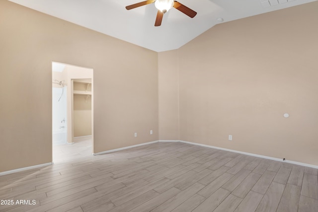 unfurnished room with baseboards, ceiling fan, vaulted ceiling, and light wood finished floors