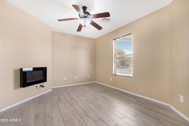 unfurnished living room with baseboards, ceiling fan, visible vents, and light wood-style flooring
