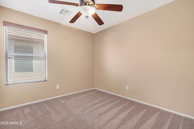 spare room featuring baseboards, carpet, a ceiling fan, and visible vents