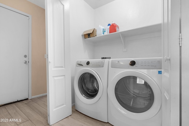laundry area featuring light wood-style floors, baseboards, laundry area, and independent washer and dryer