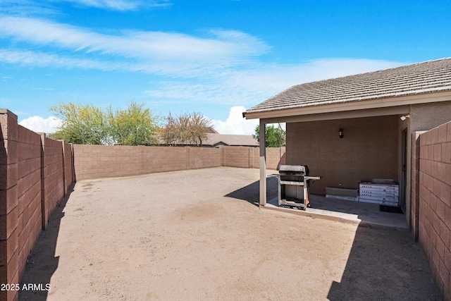 view of yard with a fenced backyard and a patio