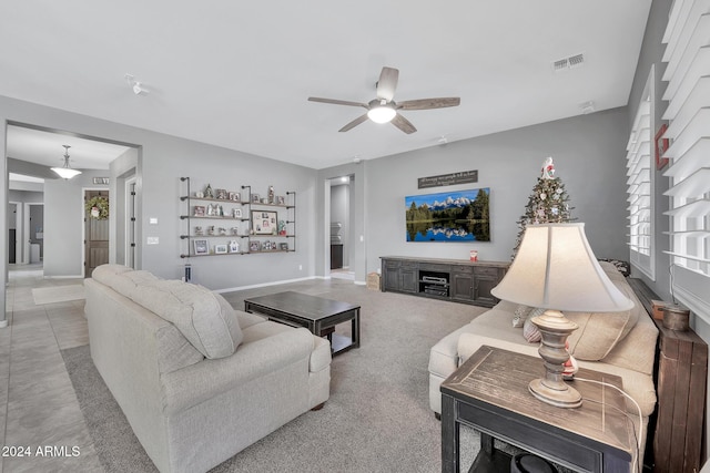 living room with ceiling fan and light colored carpet