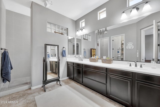 bathroom with vanity and tiled shower