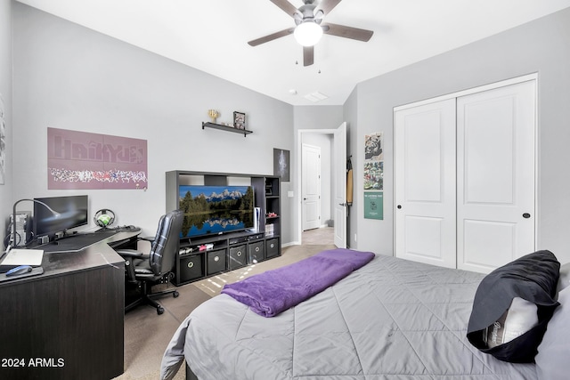 carpeted bedroom with ceiling fan and a closet