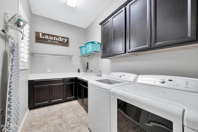 laundry room featuring cabinets, separate washer and dryer, and sink