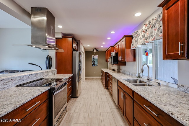 kitchen featuring island exhaust hood, sink, light stone counters, and stainless steel appliances