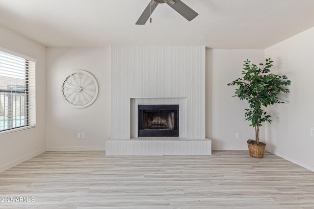 4933 E Downing St, Mesa, AZ 85205 - unfurnished living room featuring ceiling fan, wood finished floors, and a fireplace