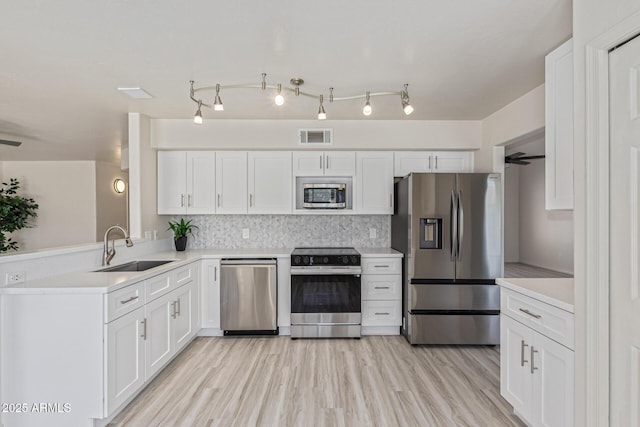 4933 E Downing St, Mesa, AZ 85205 - kitchen with appliances with stainless steel finishes, white cabinets, and light countertops