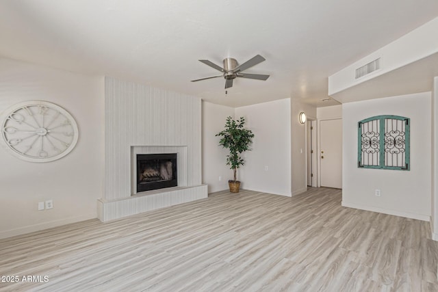 4933 E Downing St, Mesa, AZ 85205 - unfurnished living room with ceiling fan, wood finished floors, and a fireplace