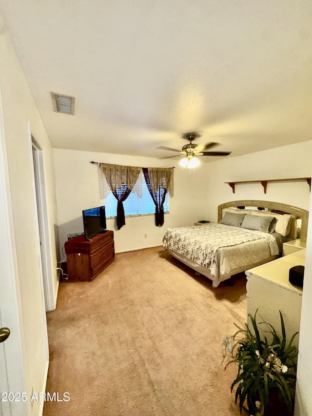 carpeted bedroom with visible vents and ceiling fan