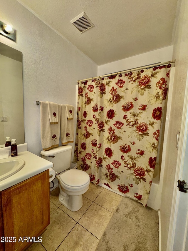 bathroom featuring vanity, visible vents, a textured ceiling, tile patterned floors, and toilet