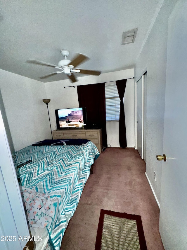 carpeted bedroom with visible vents and ceiling fan