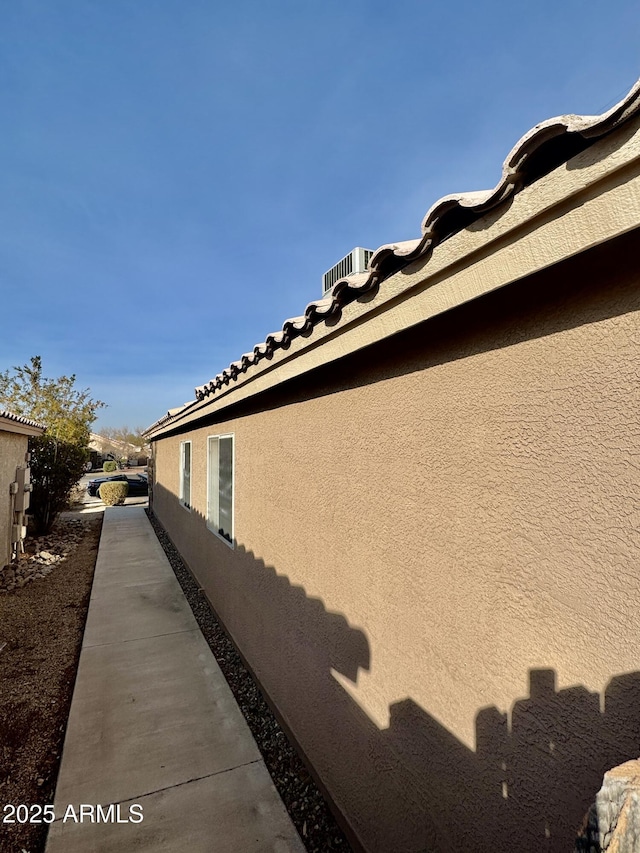 view of side of home with stucco siding