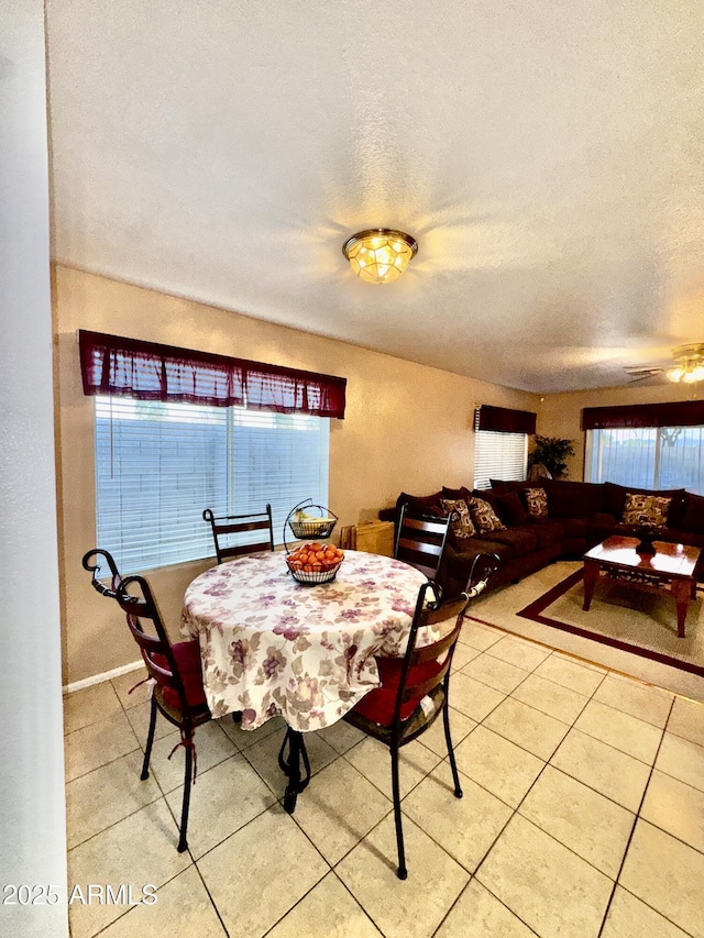 dining room featuring light tile patterned floors and a textured ceiling