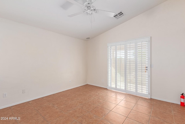 tiled empty room featuring ceiling fan and lofted ceiling