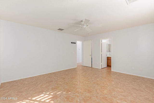 tiled empty room featuring ceiling fan