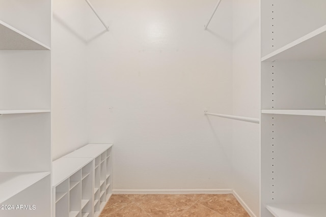 spacious closet featuring light tile patterned floors