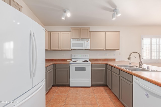 kitchen featuring white appliances, gray cabinets, sink, and light tile patterned floors