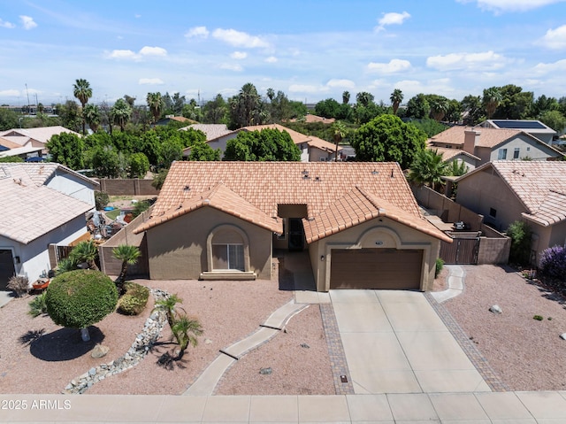 7736 W Tumblewood Dr, Peoria, AZ 85382 - view of front of property featuring a tiled roof, a garage, concrete driveway, stucco siding, and a residential view