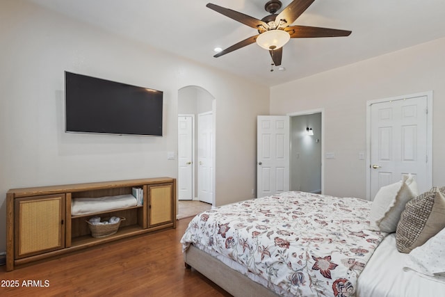 7736 W Tumblewood Dr, Peoria, AZ 85382 - bedroom with arched walkways, wood finished floors, and a ceiling fan