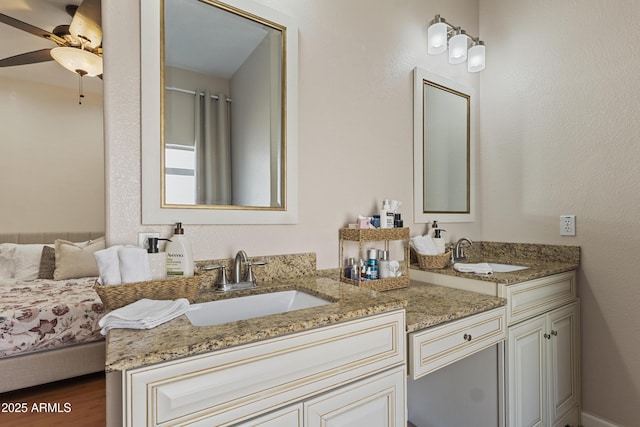 7736 W Tumblewood Dr, Peoria, AZ 85382 - full bathroom with double vanity, ceiling fan, and wood finished floors