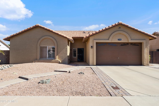 7736 W Tumblewood Dr, Peoria, AZ 85382 - mediterranean / spanish house with stucco siding, a garage, concrete driveway, and a tiled roof