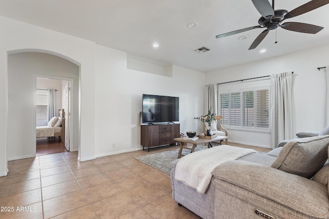 7736 W Tumblewood Dr, Peoria, AZ 85382 - living area with arched walkways, recessed lighting, light tile patterned flooring, and ceiling fan