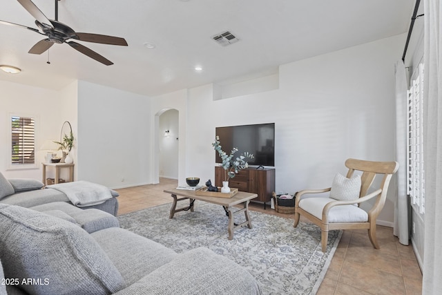 7736 W Tumblewood Dr, Peoria, AZ 85382 - living area featuring arched walkways, a ceiling fan, light tile patterned floors, and recessed lighting