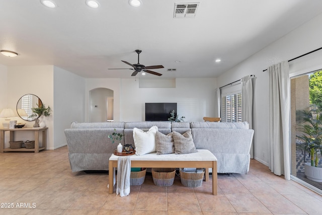 7736 W Tumblewood Dr, Peoria, AZ 85382 - living area with arched walkways, a ceiling fan, recessed lighting, and light tile patterned floors