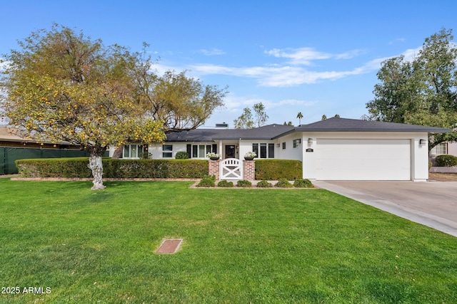 ranch-style house featuring an attached garage, a front lawn, and concrete driveway