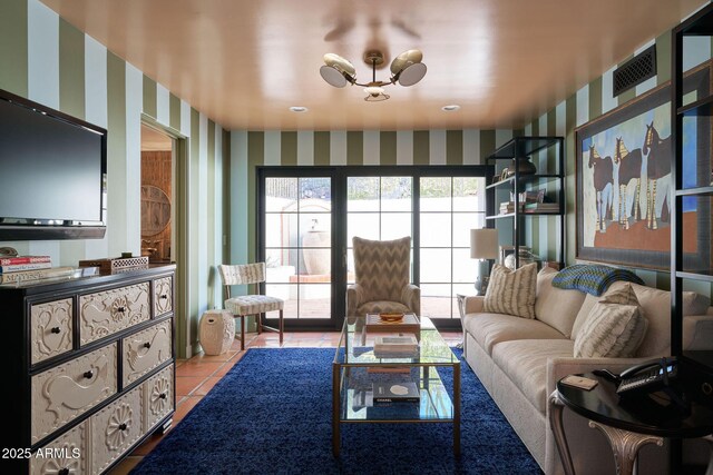 living room featuring a chandelier and light tile patterned floors