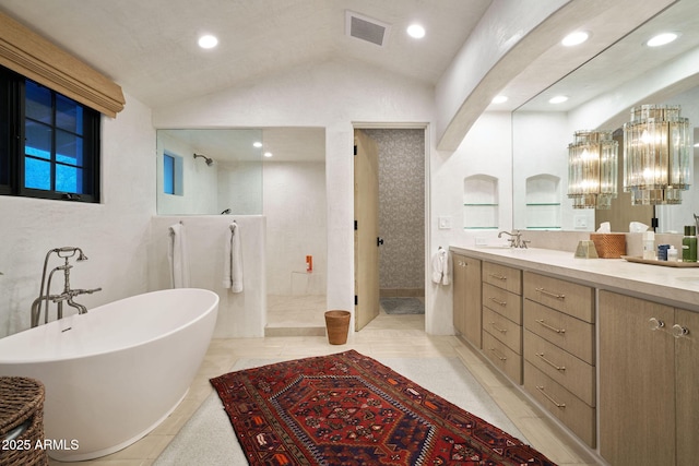 bathroom with vaulted ceiling, a chandelier, plus walk in shower, tile patterned floors, and vanity