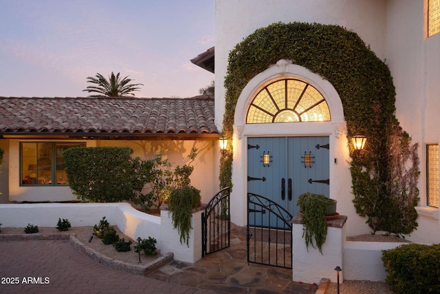 view of exterior entry at dusk