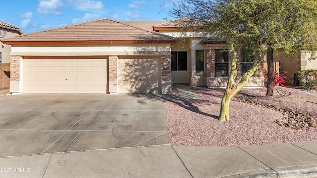 ranch-style home with driveway, stone siding, a tiled roof, an attached garage, and stucco siding