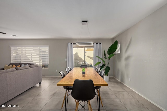 dining area with light tile patterned floors, visible vents, and baseboards