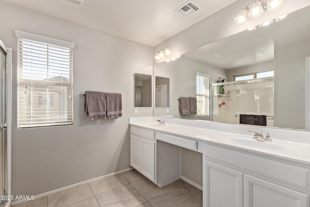 full bathroom featuring double vanity, visible vents, a sink, a shower stall, and tile patterned floors