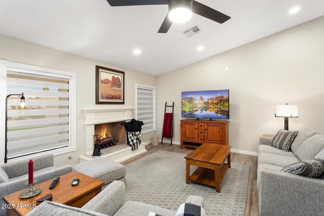 living room with ceiling fan, hardwood / wood-style floors, and lofted ceiling