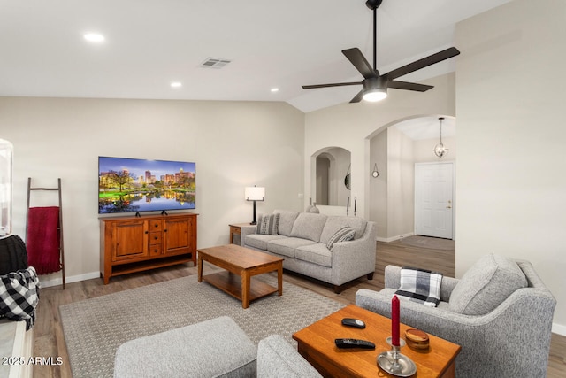 living room featuring hardwood / wood-style flooring, lofted ceiling, and ceiling fan