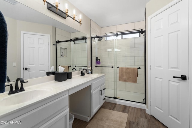 bathroom featuring hardwood / wood-style floors, an enclosed shower, and vanity