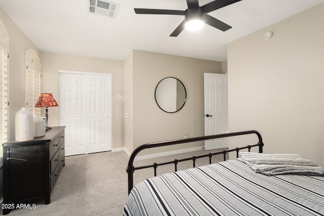 bedroom featuring ceiling fan, a closet, and light carpet