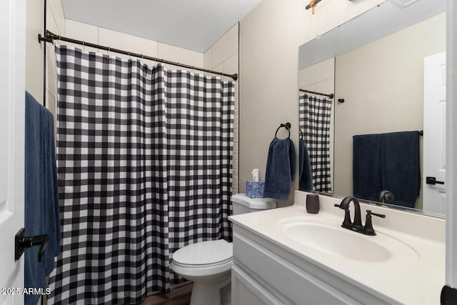 bathroom with vanity, toilet, and hardwood / wood-style flooring