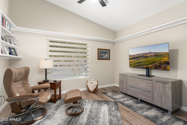 living area featuring wood-type flooring, vaulted ceiling, and ceiling fan